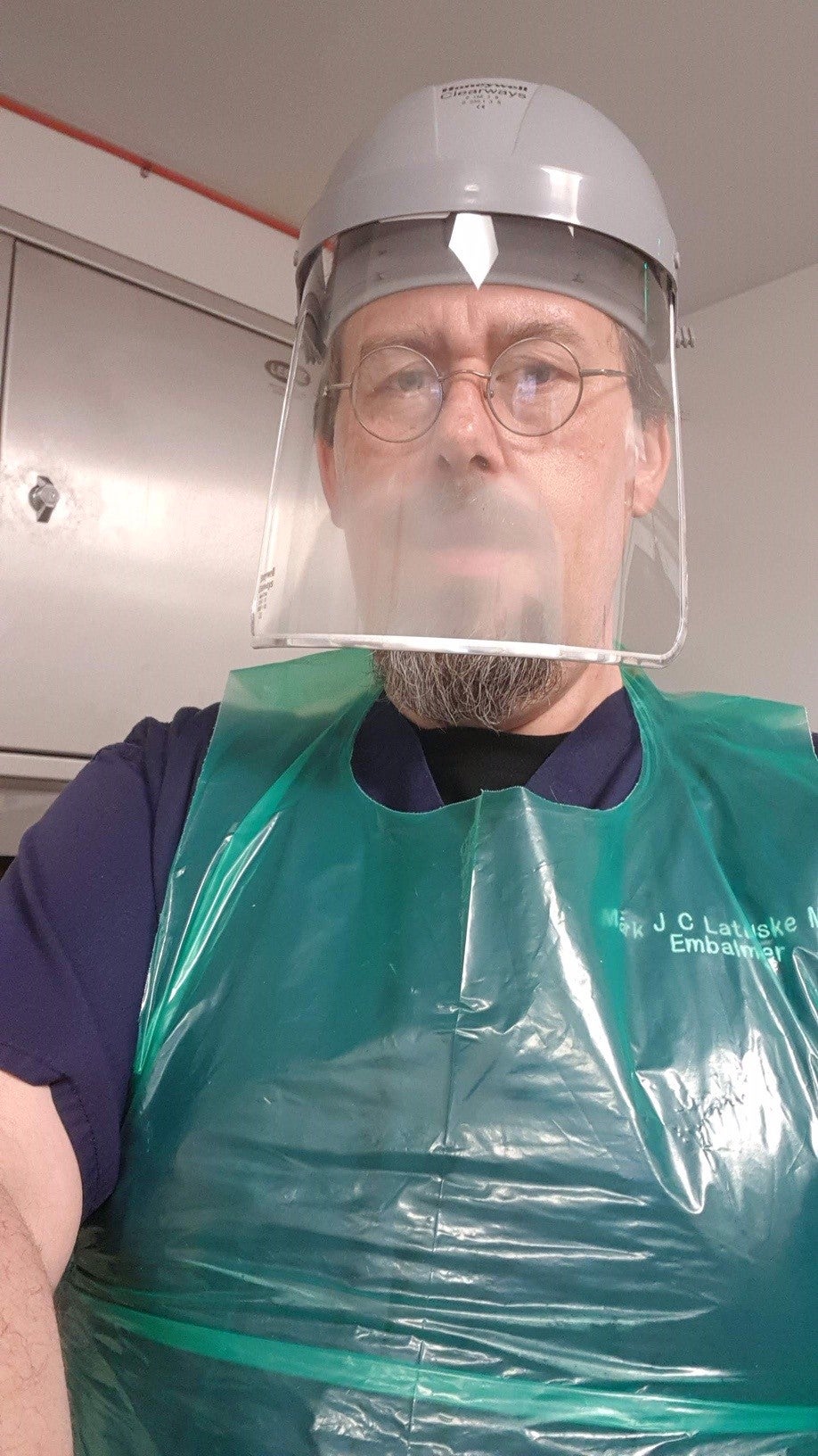 Mark in some of the protective equipment he uses working as an embalmer (PA Real Life)