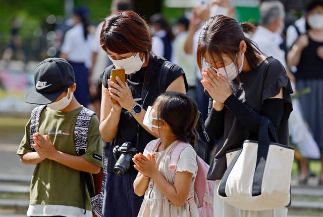 <p>People pray at the Atomic Bomb Hypocenter Park on the 77th anniversary of the atomic bombing in Nagasaki, southern Japan</p>