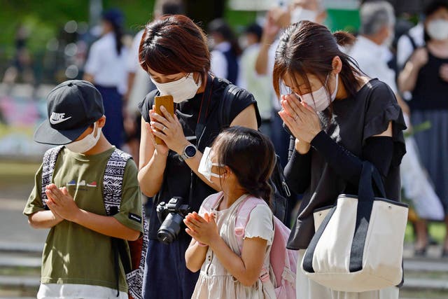 <p>People pray at the Atomic Bomb Hypocenter Park on the 77th anniversary of the atomic bombing in Nagasaki, southern Japan</p>