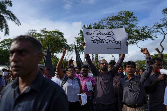 <p>File photo: Trade union and civil society activists led by leftists' People Liberation Front shout slogans denouncing president Ranil Wickremesinghe in Colombo on 9 August </p>