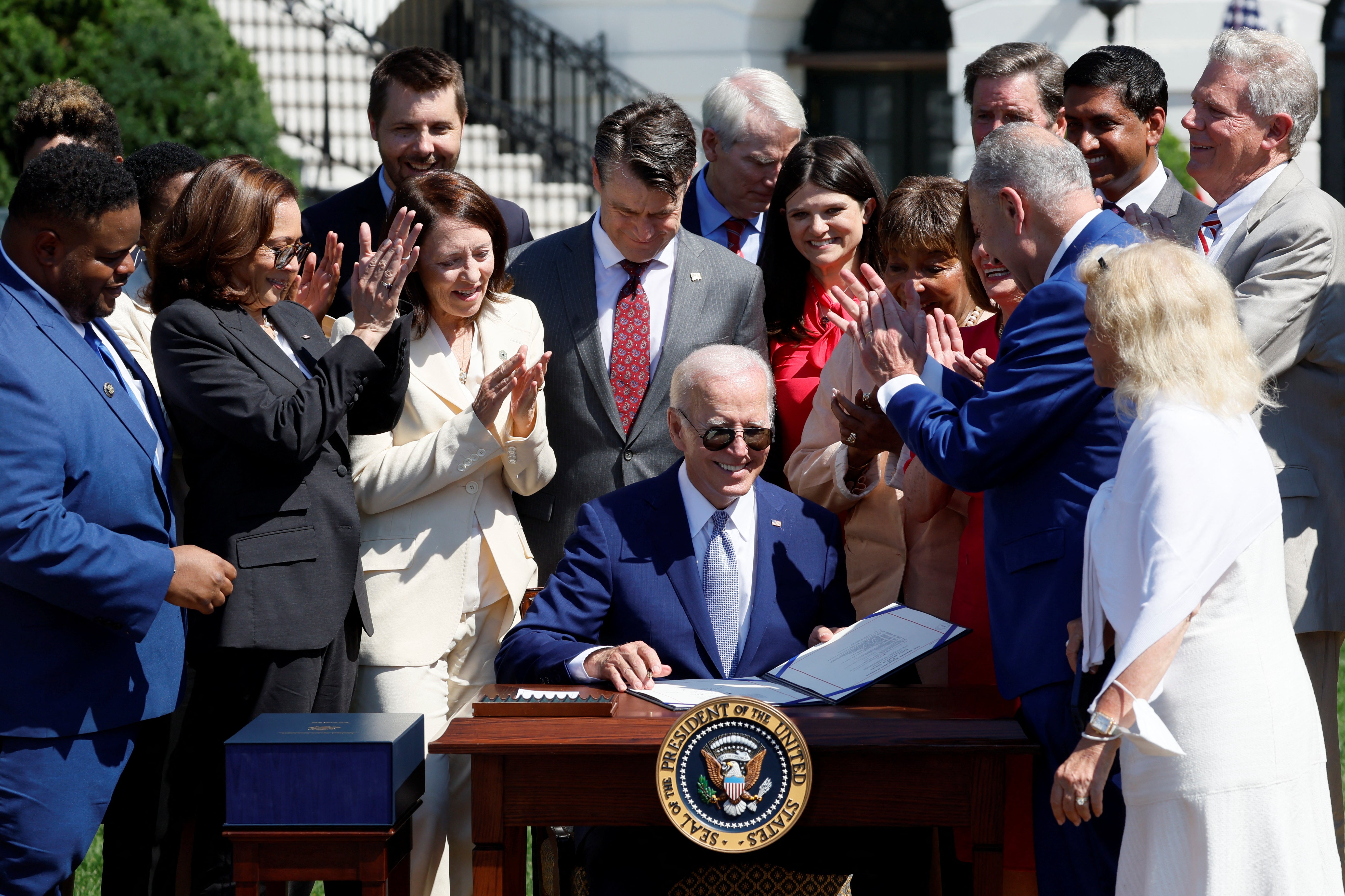 US president Joe Biden signs the CHIPS and Science Act of 2022 alongside vice president Kamala Harris, House of Representatives speaker Nancy Pelosi and Joshua Aviv, founder and CEO of SparkCharge, on the South Lawn of the White House in Washington, 9 August 2022