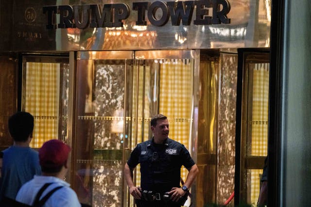 <p>A New York City police officer stands in front of Trump Tower on 8 August 2022</p>