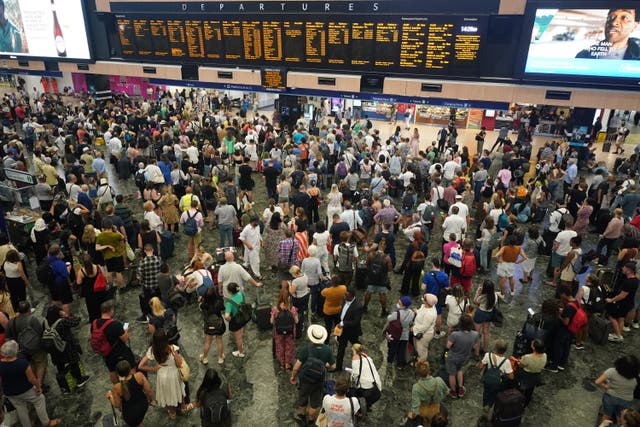 Passengers at Euston station in London (Yui Mok/PA)