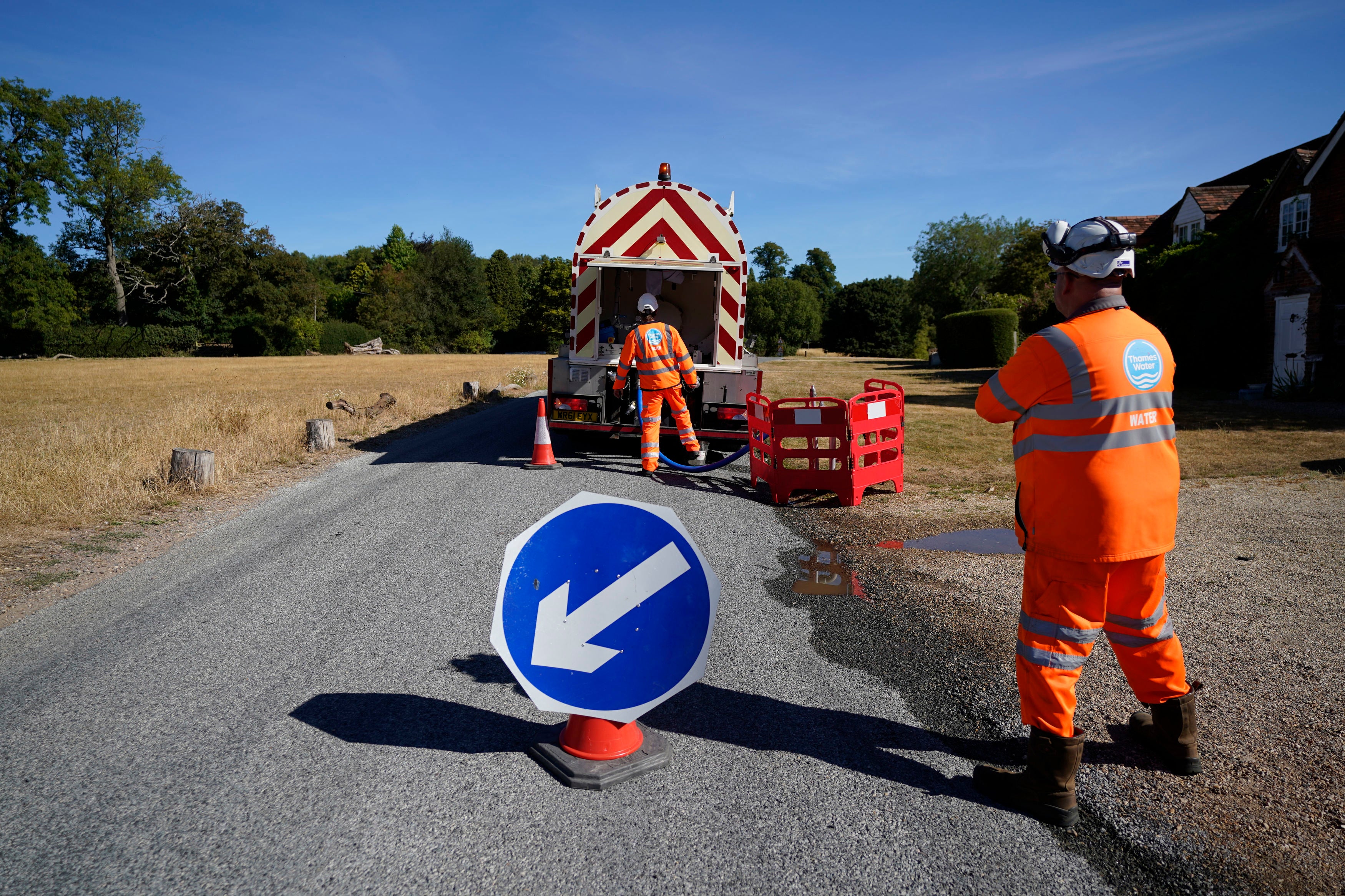 A worker from Thames Water delivering a temporary water supply from a tanker to the village of Northend in Oxfordshire.