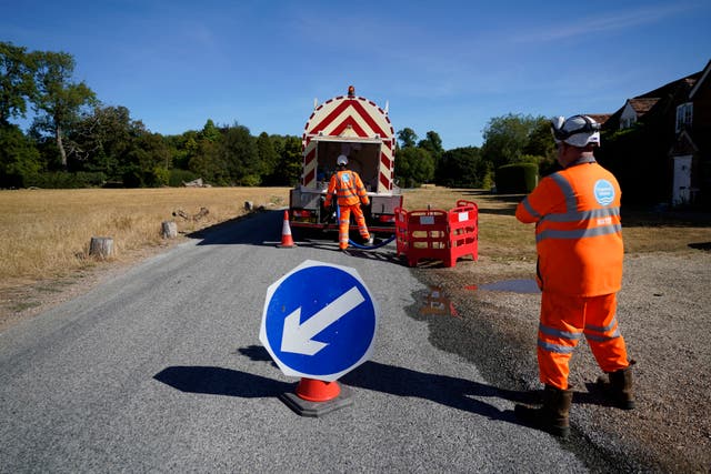 <p>A worker from Thames Water delivering a temporary water supply from a tanker to the village of Northend in Oxfordshire.</p>