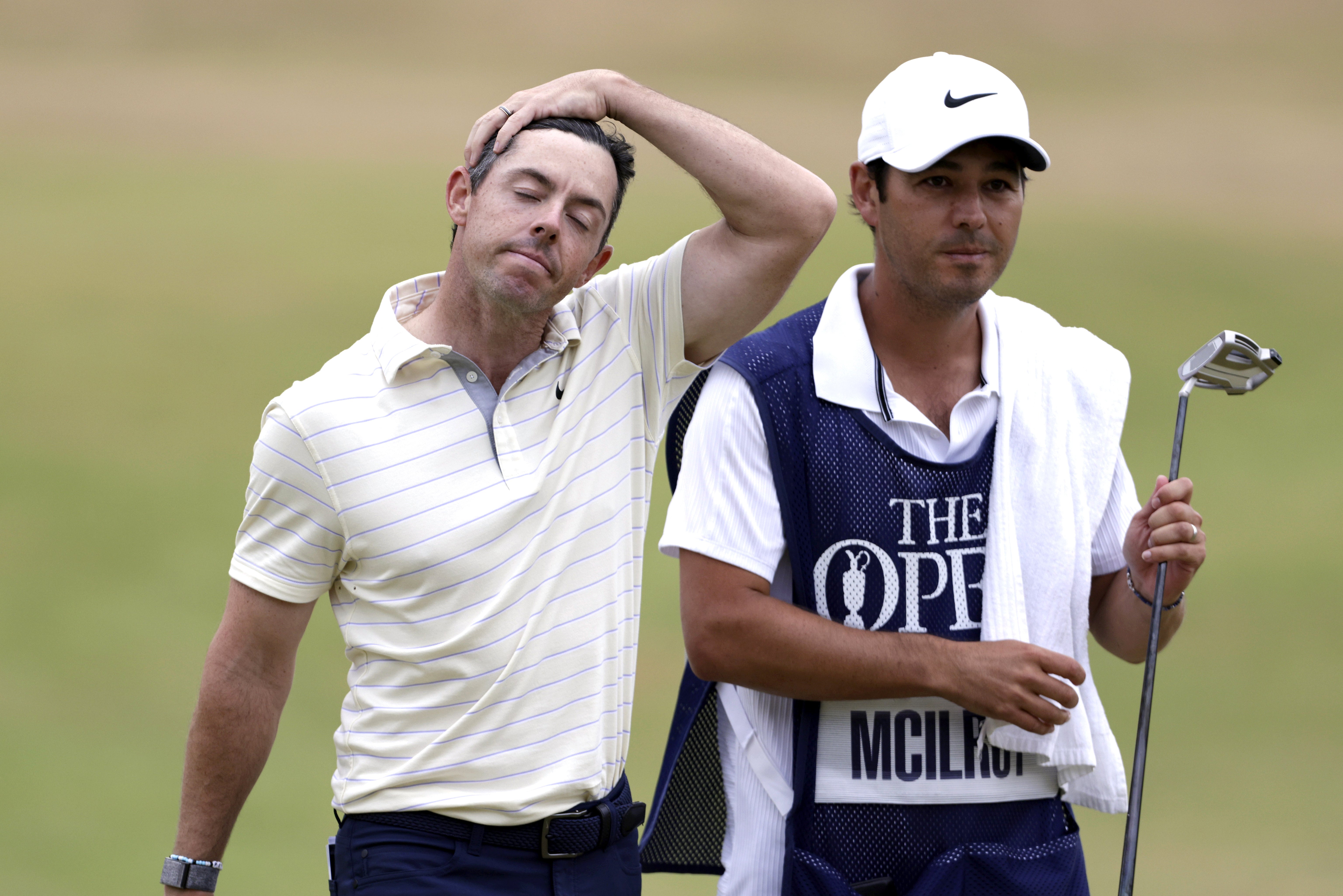 Rory McIlroy (left) looks dejected after finishing third in the 150th Open at St Andrews