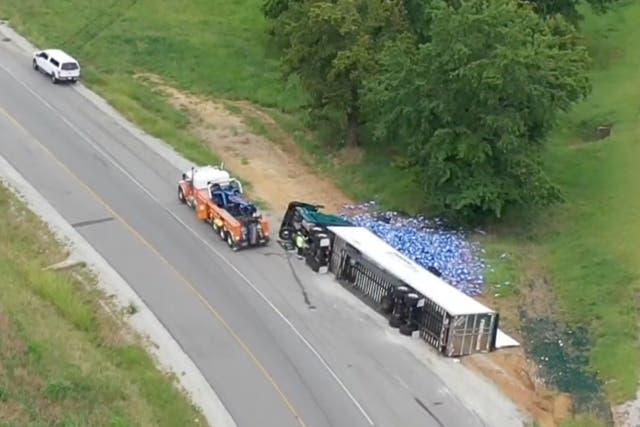 <p>The road was later cleared of thousands of Bud Light cans</p>
