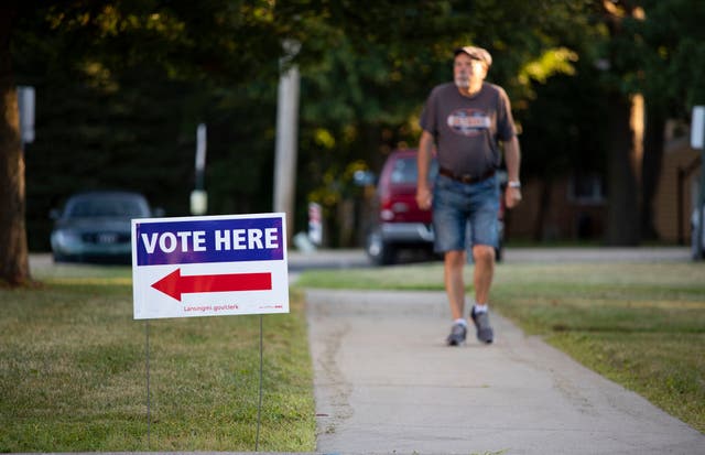 <p>A voter heads to the polls in Michigan</p>