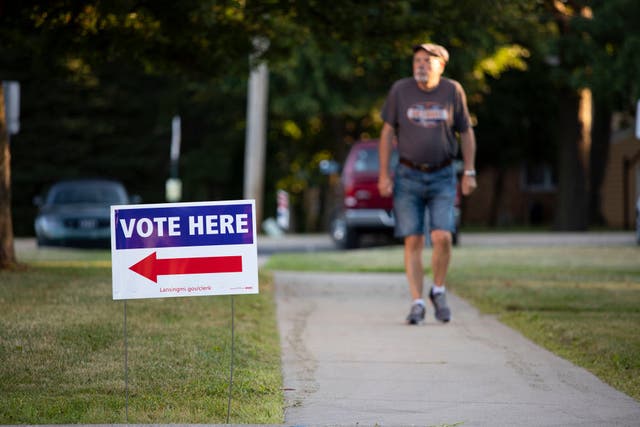 <p>A voter heads to the polls in Michigan</p>