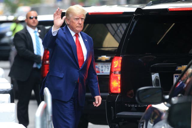 <p>Former US President Donald Trump waves while walking to a vehicle outside of Trump Tower in New York City on August 10, 2022</p>