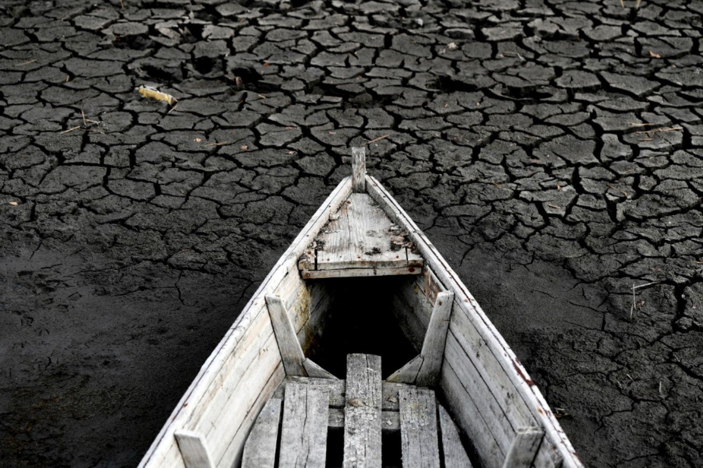 A boat lays on the dried lake bed in Velence, Hungary