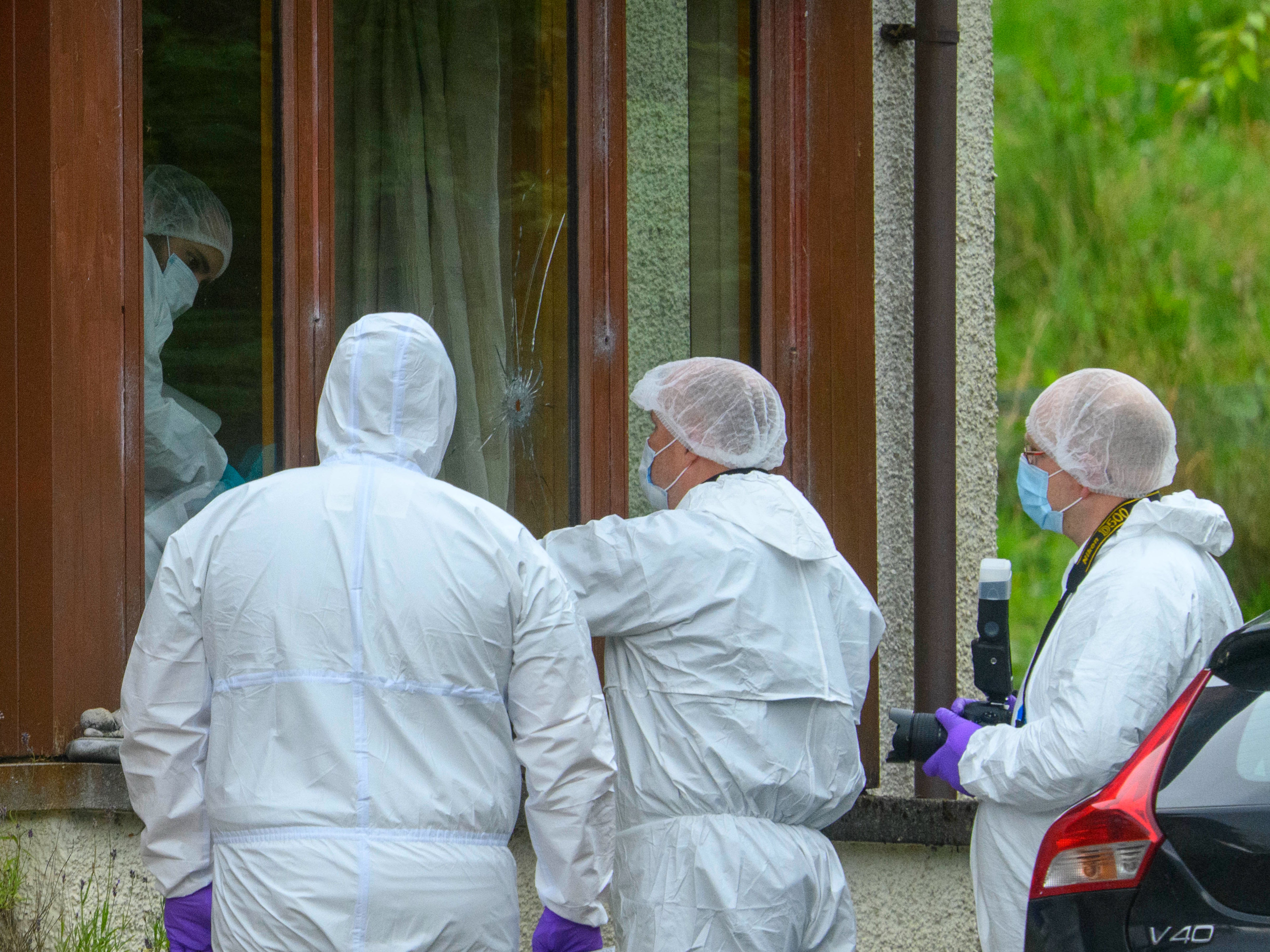 Forensics officers at the scene of an incident at a property in the Dornie area of Wester Ross, on the northwest coast of Scotland