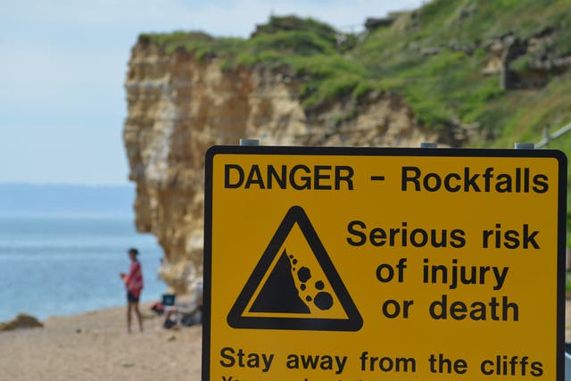<p>A rockfall warning in Dorset where the council is urging people to take precautions around the cliffs during the hot dry weather</p>