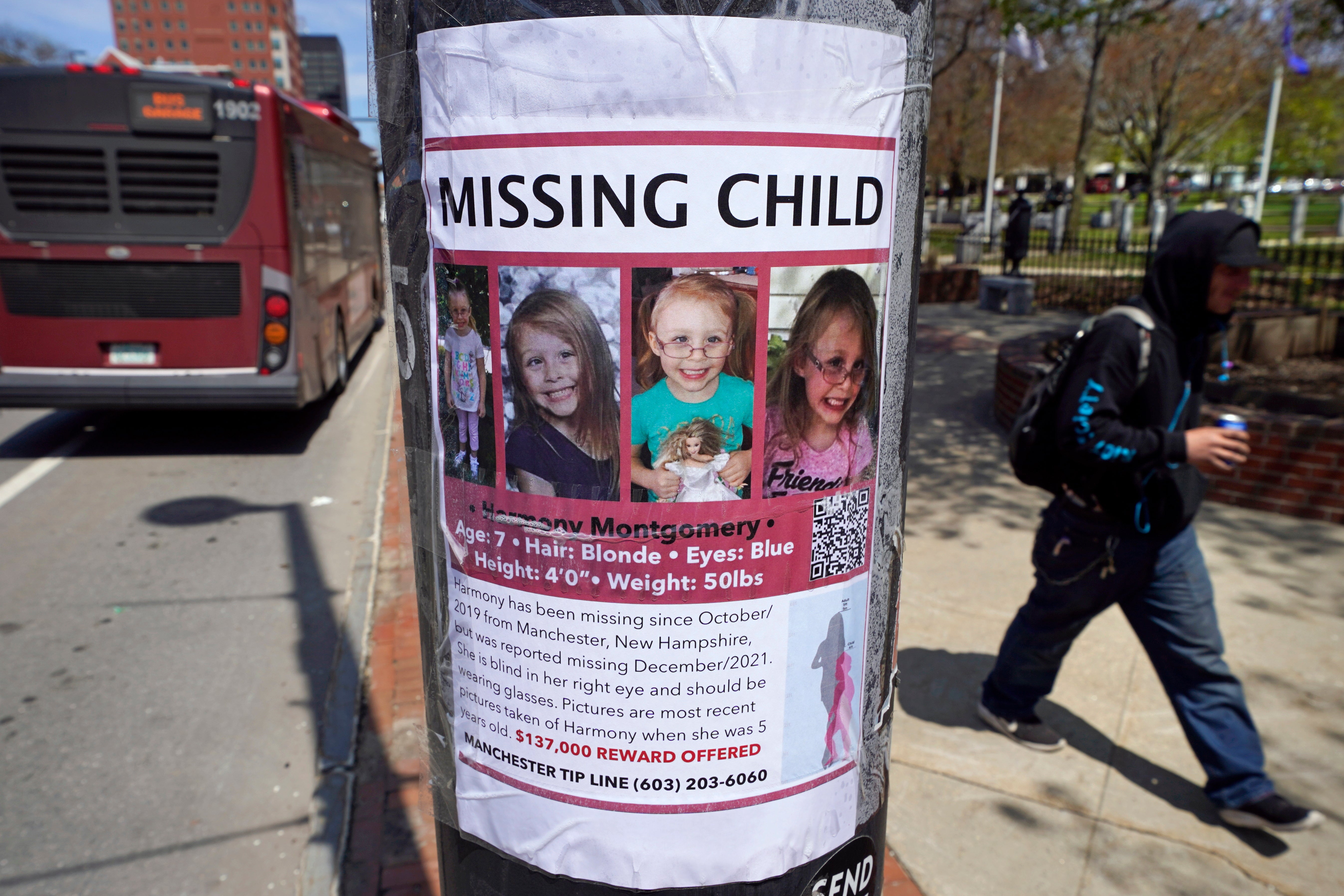 FILE - A man walks past the ‘missing child’ poster for Harmony Montgomery on Thursday, 5 May, 2022, in Manchester, New Hampshire