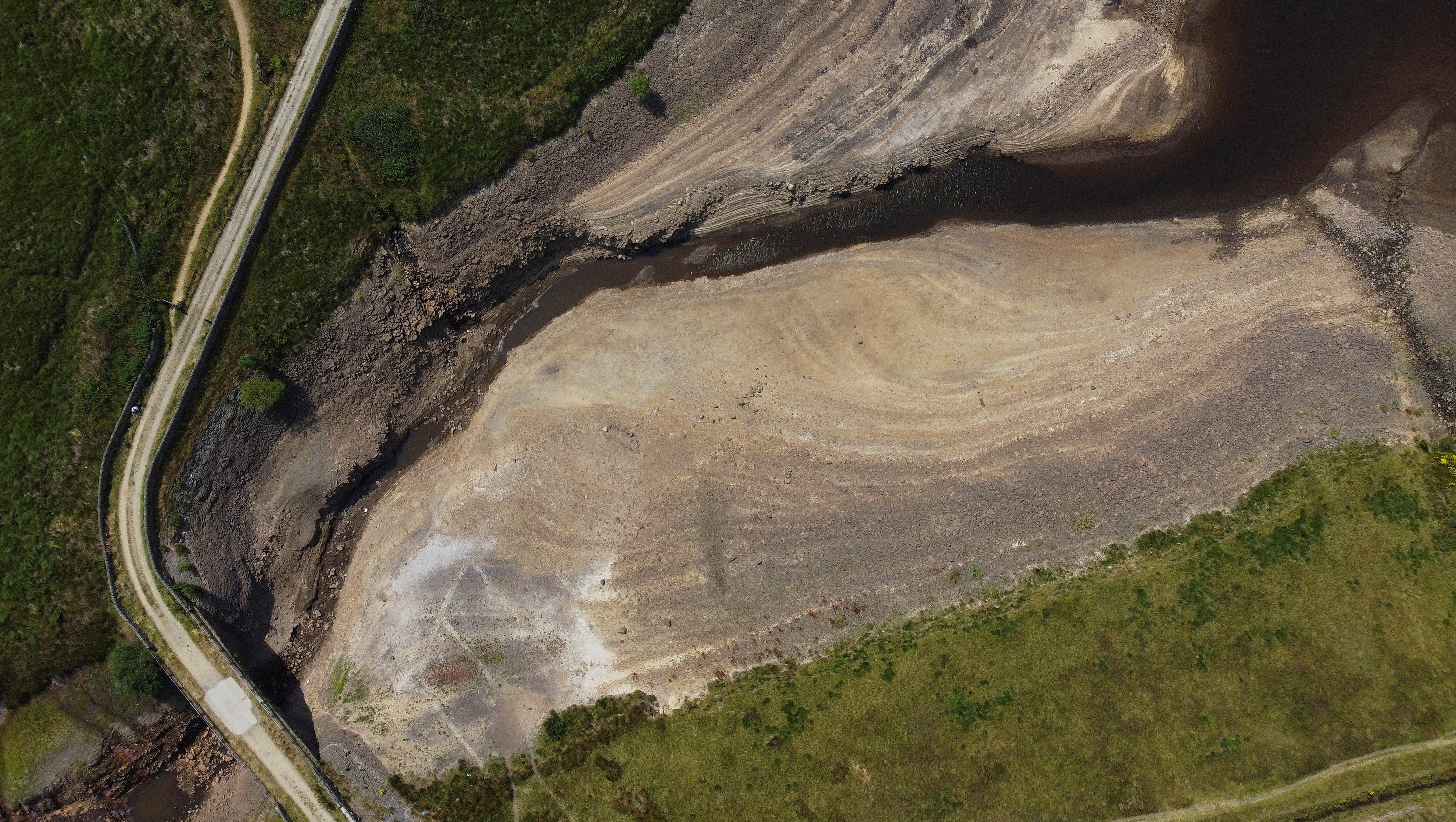 A dry bank of a tributary to the Dowry reservoir during the continuing hot weather, near Oldham in July