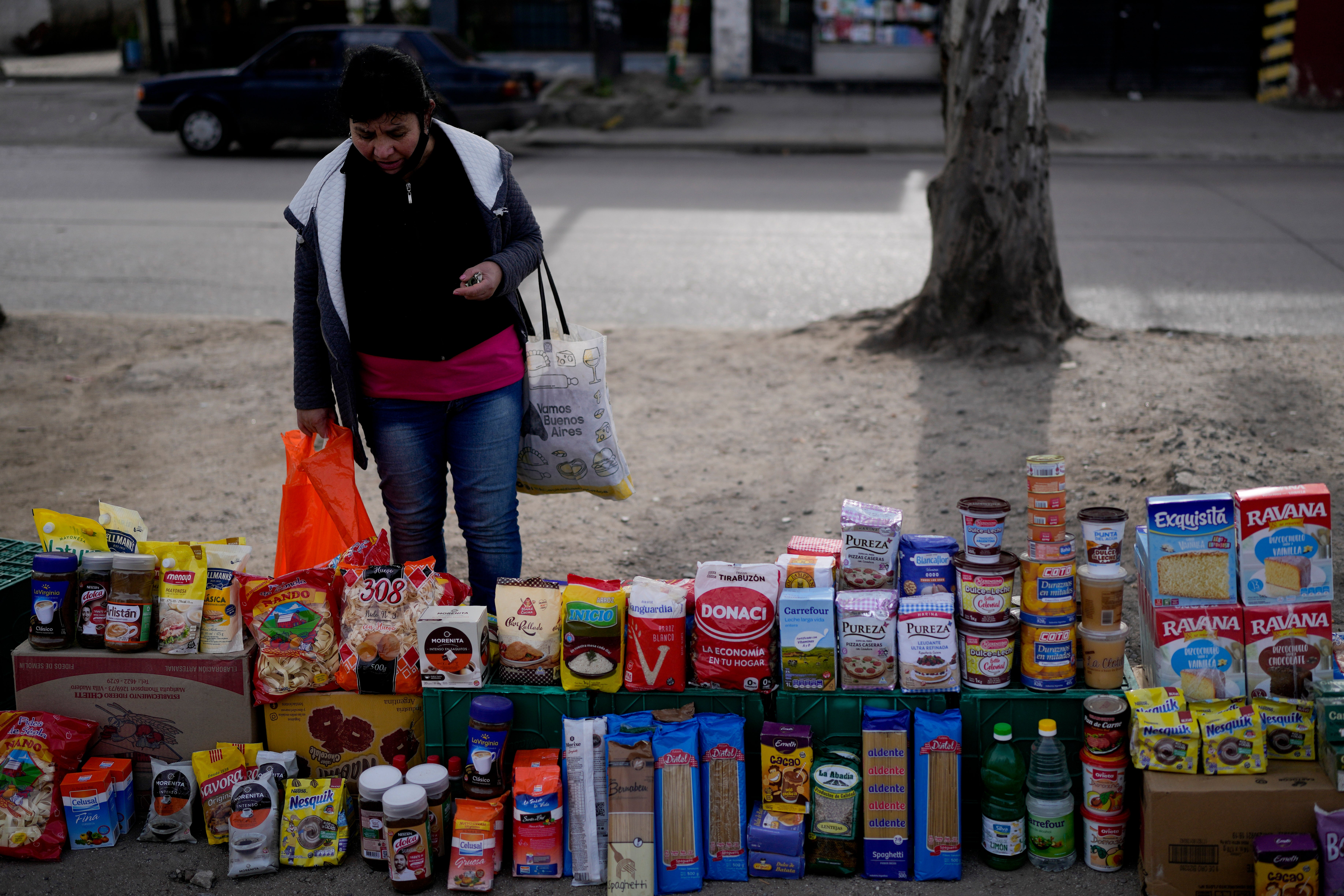 <p>A woman in Argentina browses a market </p>