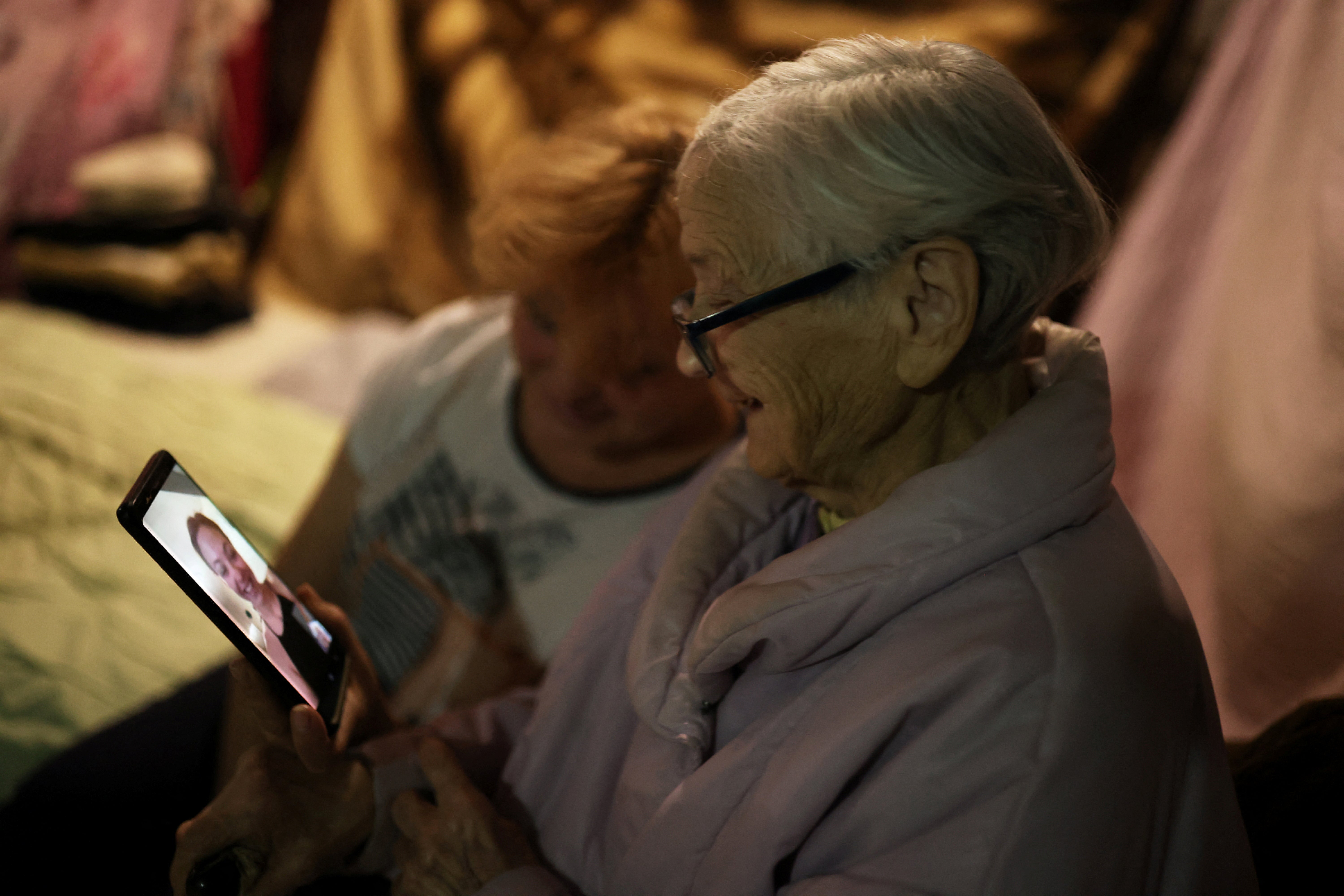 Maria speaks to her granddaughter Masha who lives in New York, on a phone