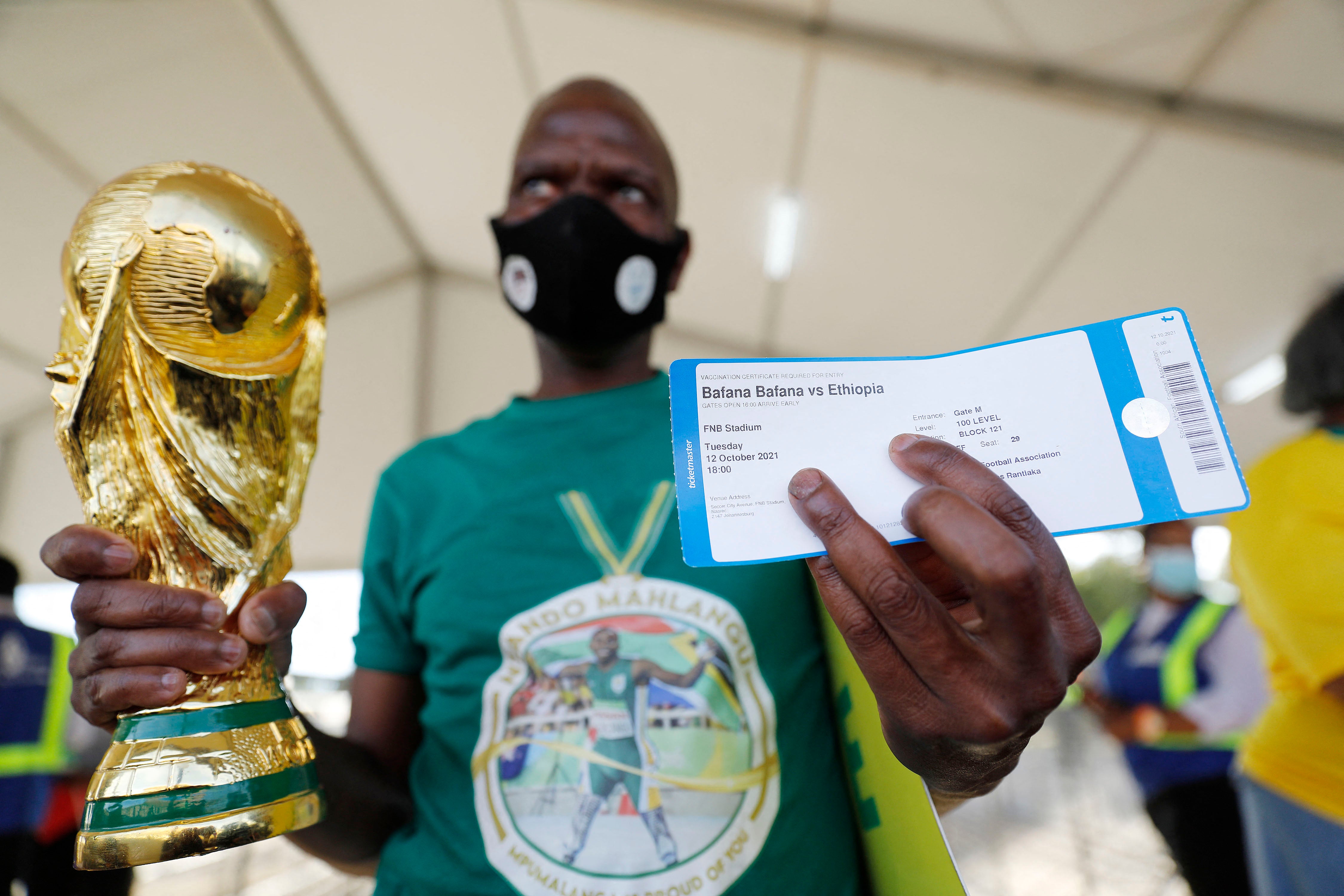 A South African national football team supporter holds his ticket