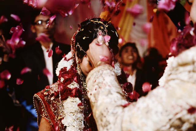 <p>FILE-The bride and groom at the Indian wedding garlands or Jaimala ceremony on the stage.</p>
