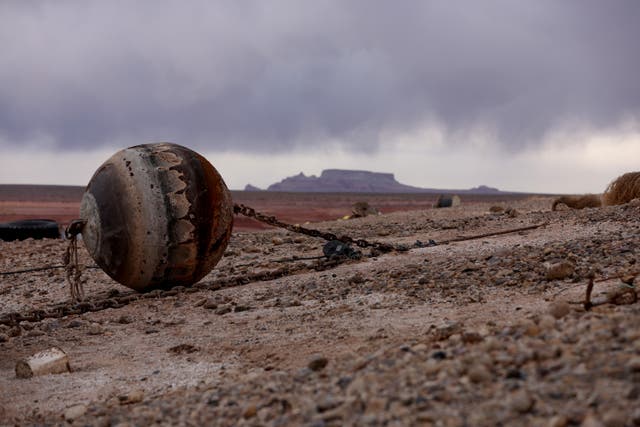<p>A buoy sits on dry land at Lake Powell in March 2022 </p>