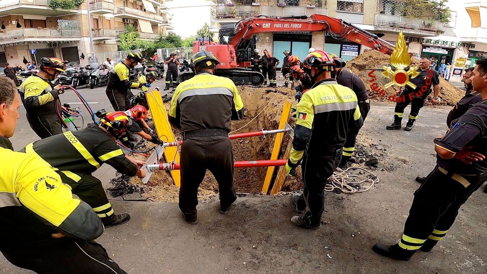 Italian firefighters dig up the road to rescue a man blocked in the tunnel
