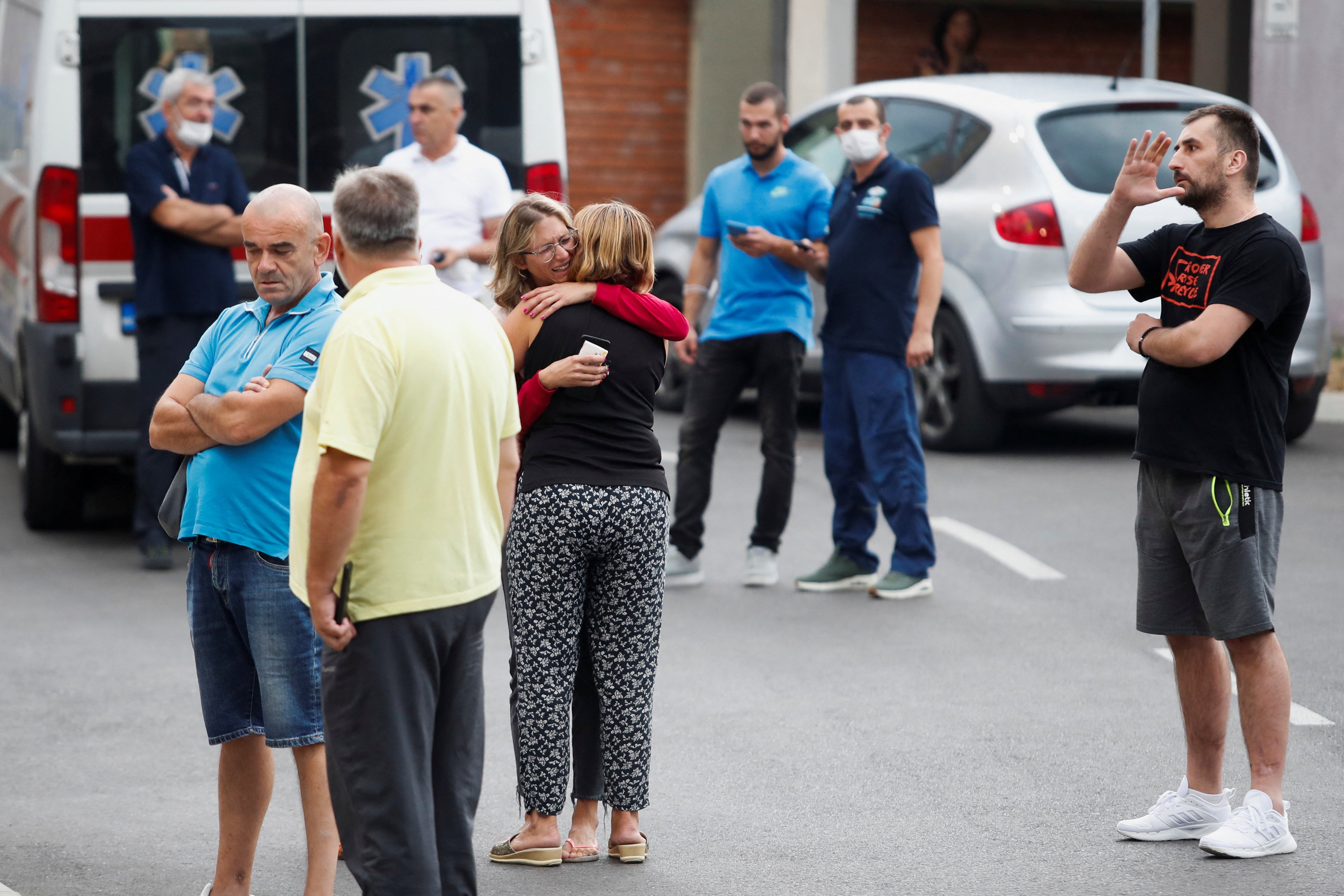 Relatives of victims wait in front of a city hospital after the shooting