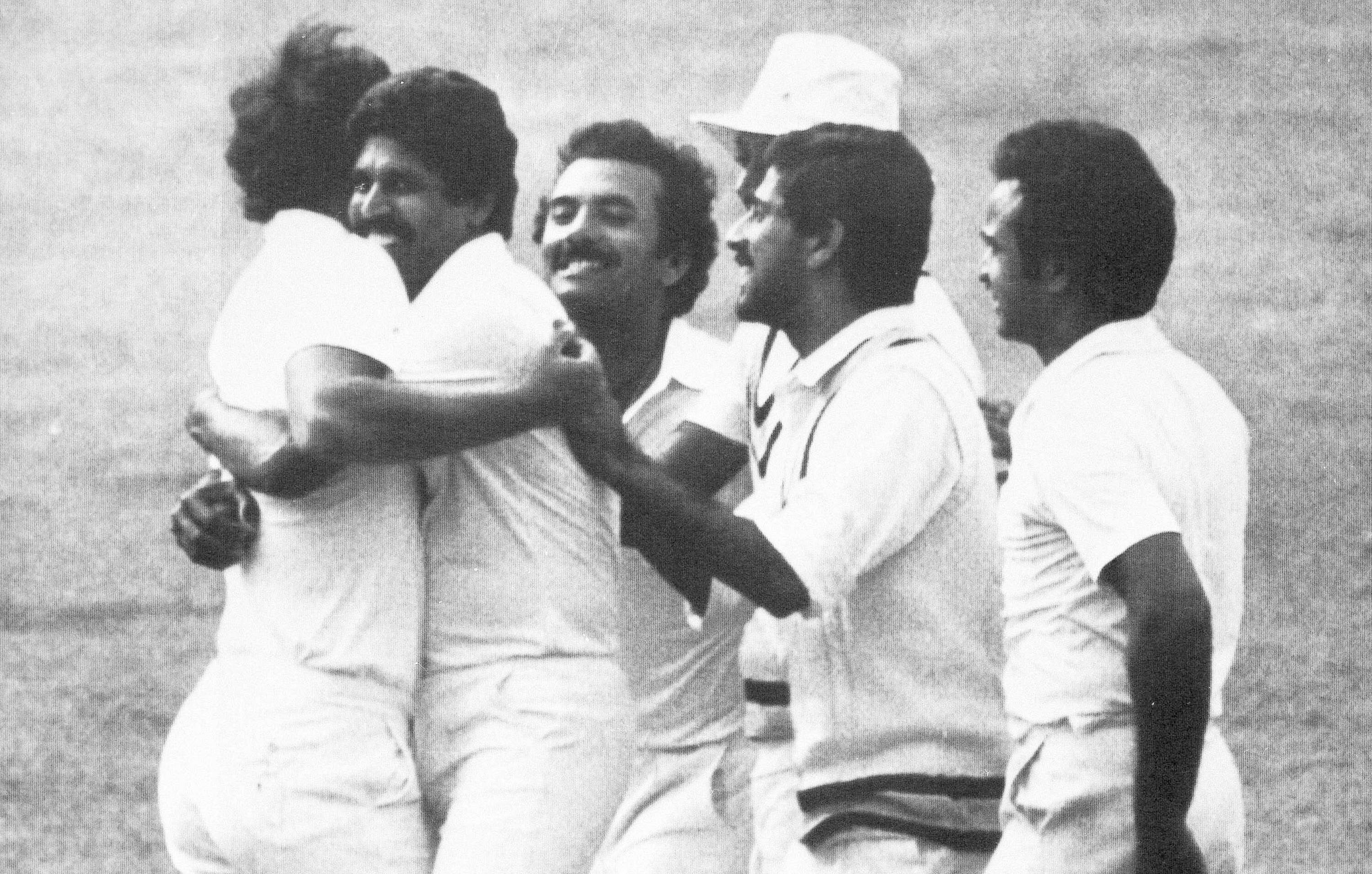 Indian cricket team captain Kapil Dev, second from left, hugs Indian bowler Madan Lal while the rest of the Indian team celebrate at Lord's after Gavaskar had caught West Indian, Larry Gomes, for five of the bowling of Madan Lal during the Prudential World Cup Final in London, 25 June 1983. India won the World Cup for the first time in 1983