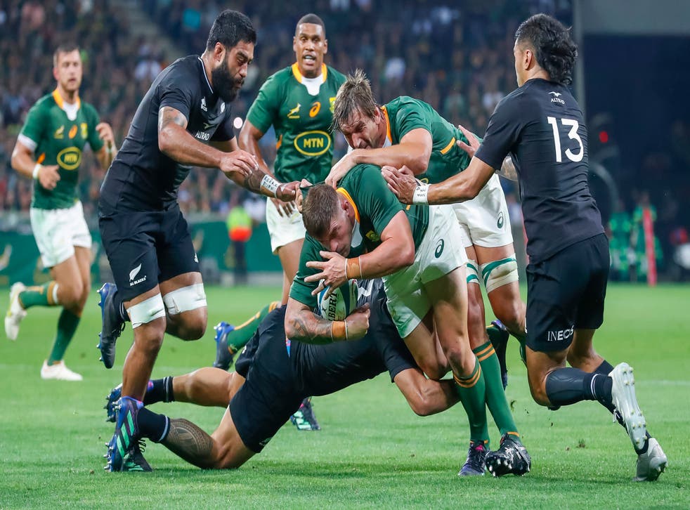 <p>Malcolm Marx of South Africa fends off a tackle against New Zealand</p>