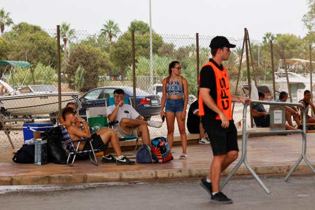 <p>Young people leave the Medusa music festival after high winds caused part of a stage to collapse in Cullera, near Valencia</p>