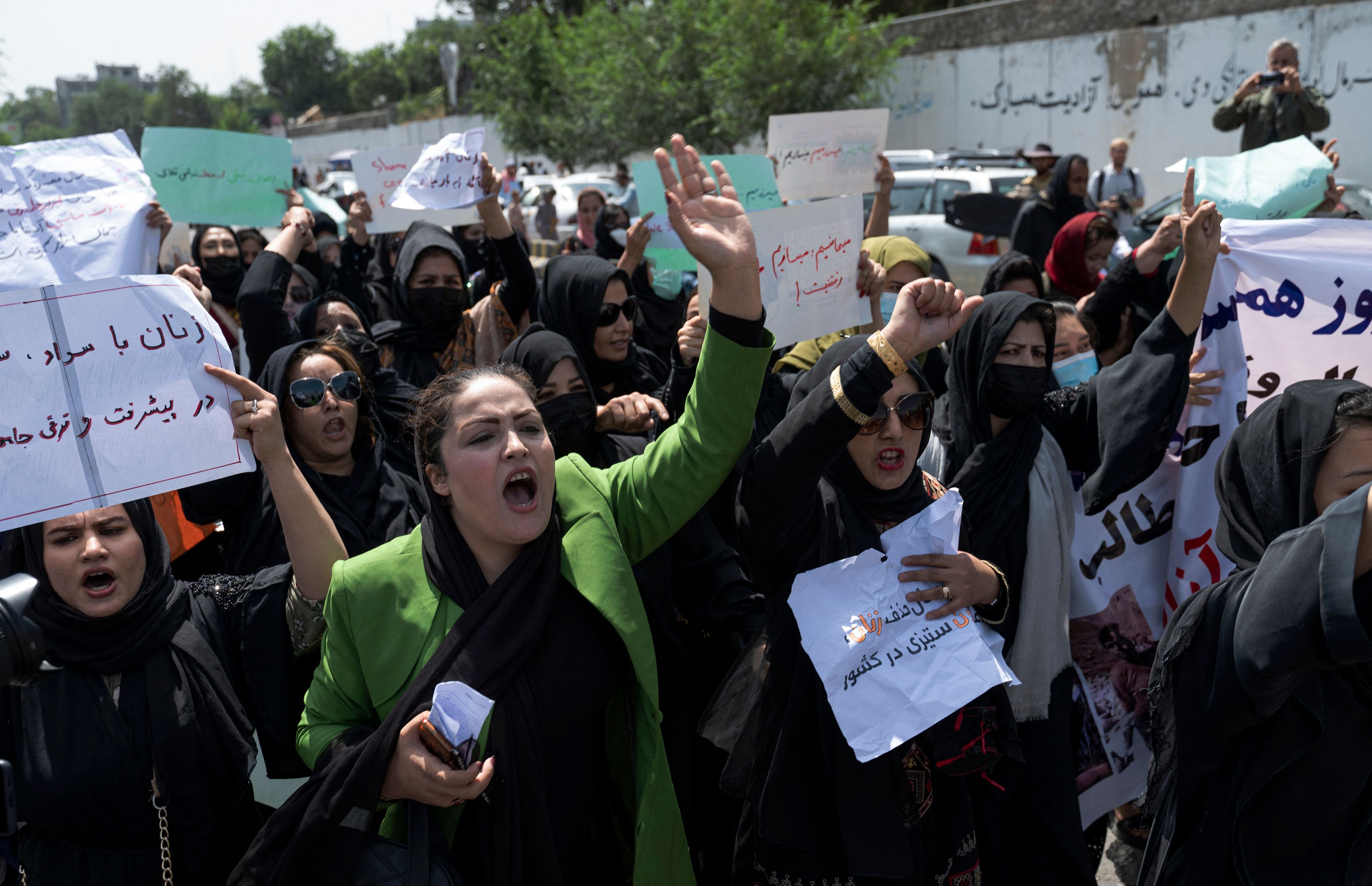 Afghan women hold placards during a women’s rights protest in Kabul on 13 August