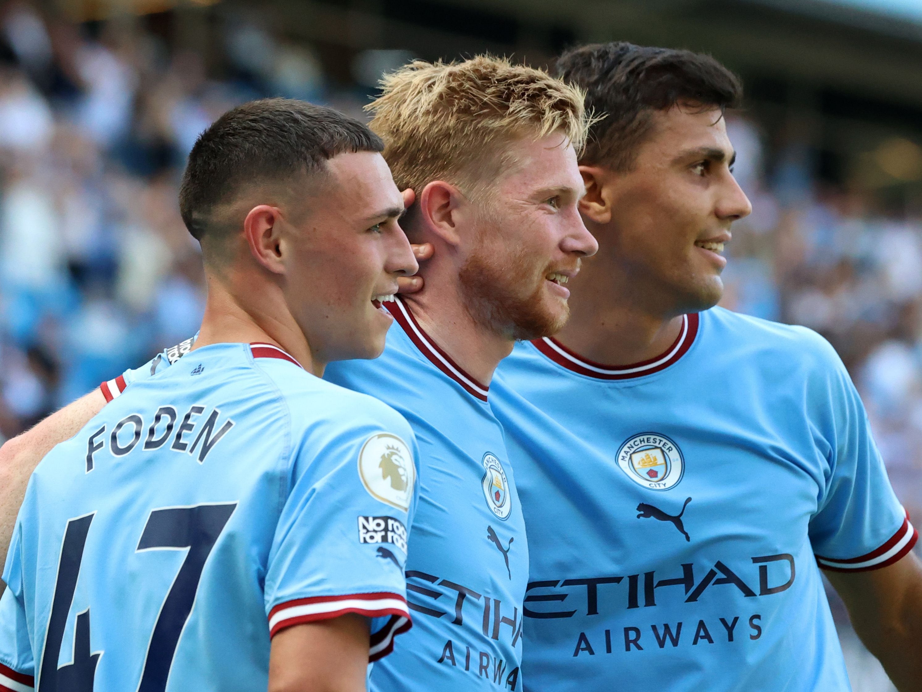 <p>Kevin de Bruyne of Manchester City celebrates with teammates Phil Foden and Rodri after scoring his side’s second goal after 30 minutes</p>