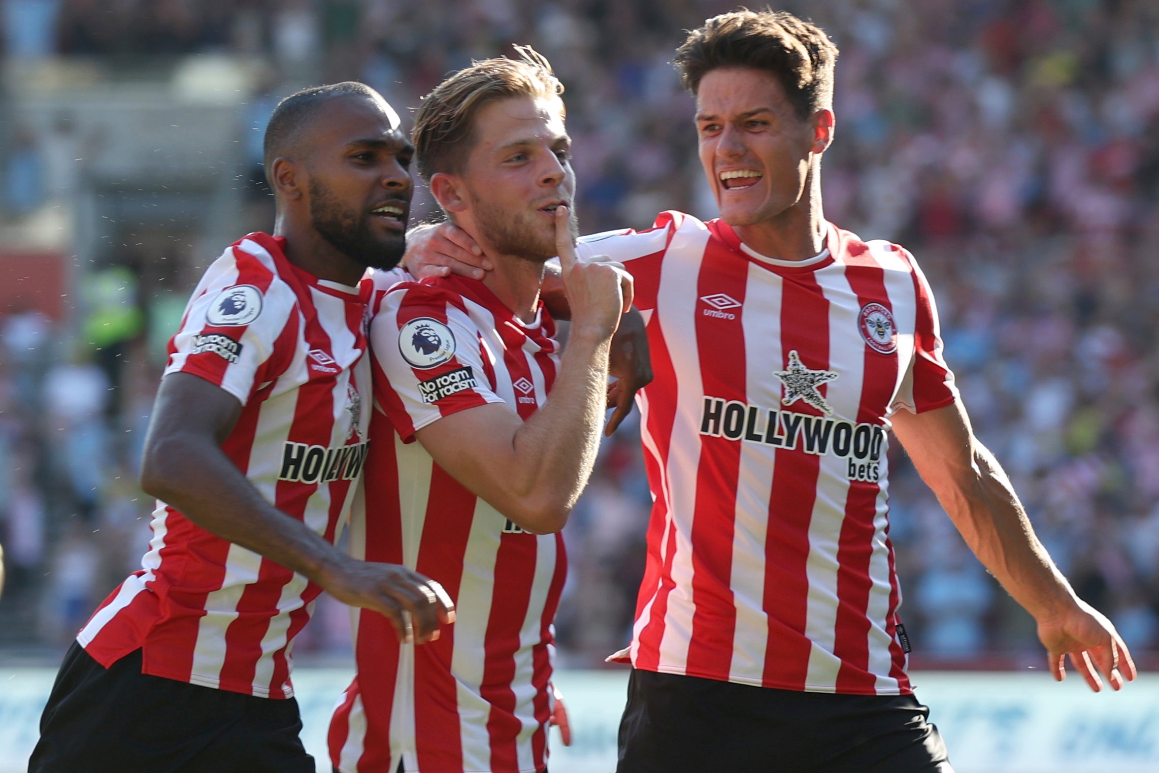 Brentford's Mathias Jensen, centre, celebrates with teammates