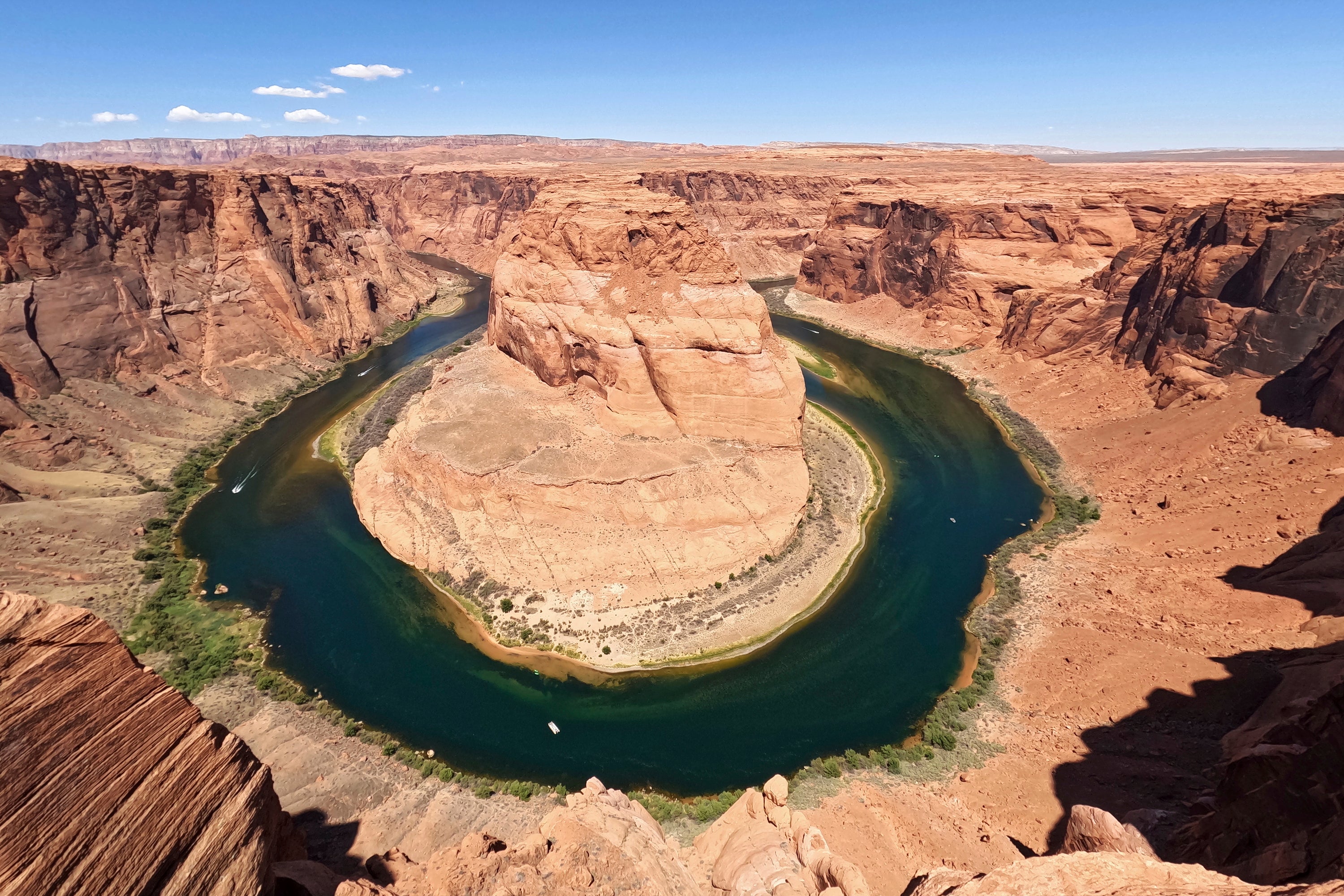 The Colorado River flows at Horseshoe Bend in the Glen Canyon National Recreation Area, Wednesday, June 8, 2022, in Page, Arizona. The region is facing a historic drought