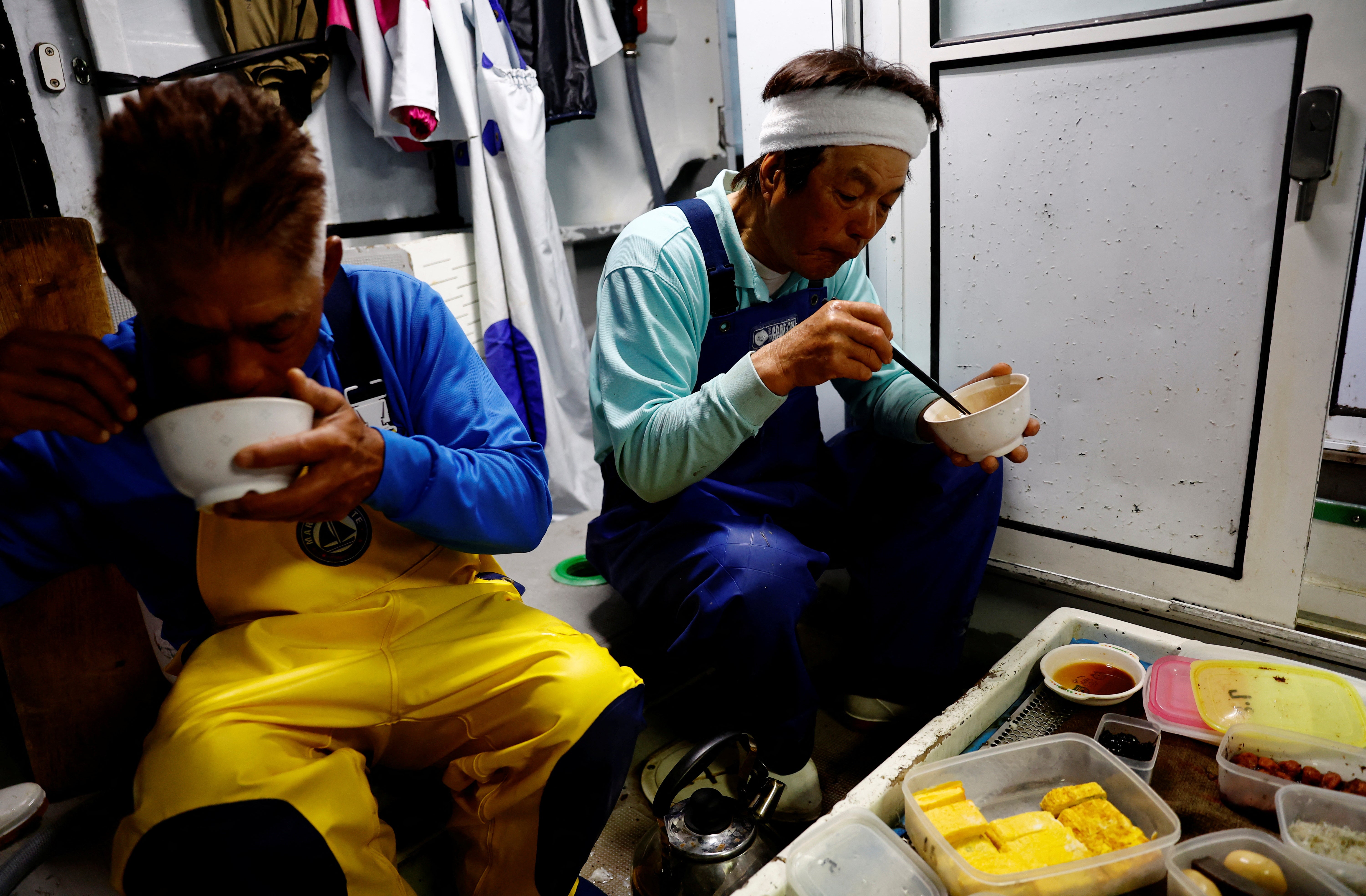 Takeo Nakajo, captain of the Nakajomaru katsuo, eats breakfast with his crew before work