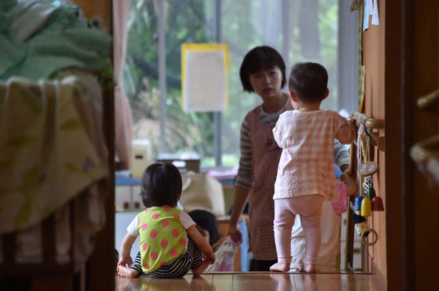 <p>An employee of an official nursery school taking care of young children in Yokohama, Japan </p>