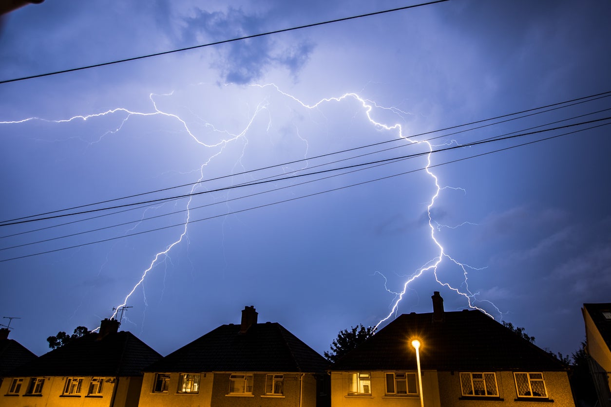 A lightning storm is pictured above houses in Essex.