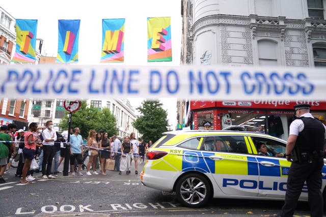 Crowds at the police cordon at Poland Street, central London (Victoria Jones/PA)