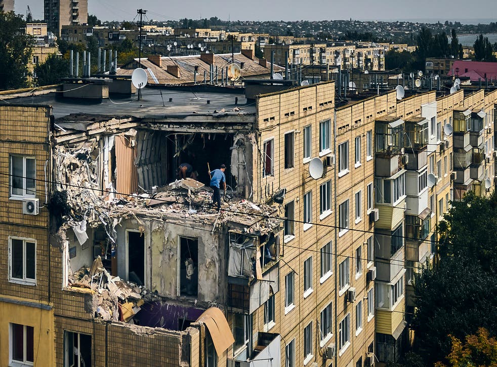 <p>A man cleans an apartment destroyed after Russian shelling in Nikopol, Ukraine, in August 2022 </p>