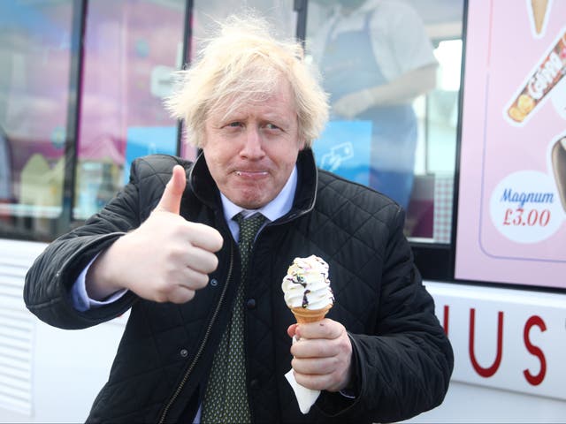 <p>Boris Johnson gives a thumbs up while tucking into an ice cream during a visit to Haven Perran Sands Holiday Park in Perranporth, Cornwall, in April 2021</p>