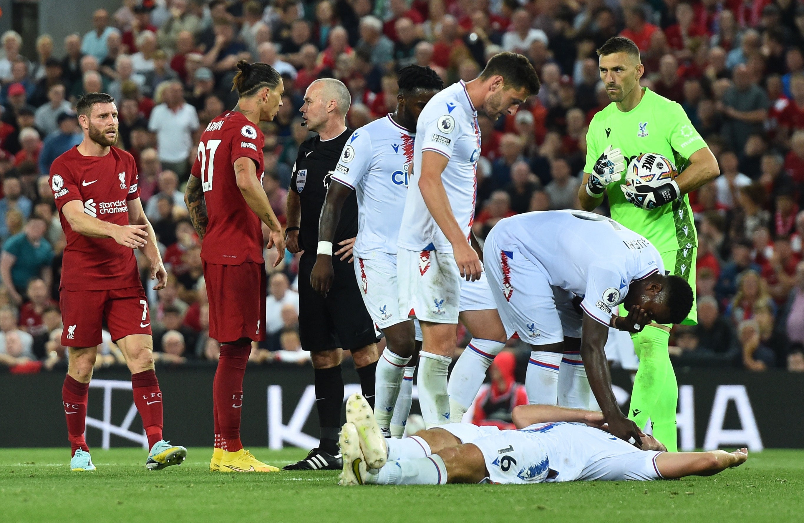Crystal Palace’s Joachim Andersen is on the floor after sustaining an injury as Liverpool’s Darwin Nunez is sent off