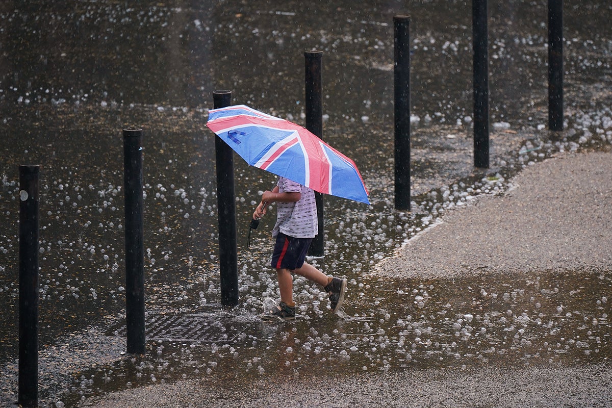 UK weather – live: London’s Victoria station floods amid ‘danger to life’ storm warning