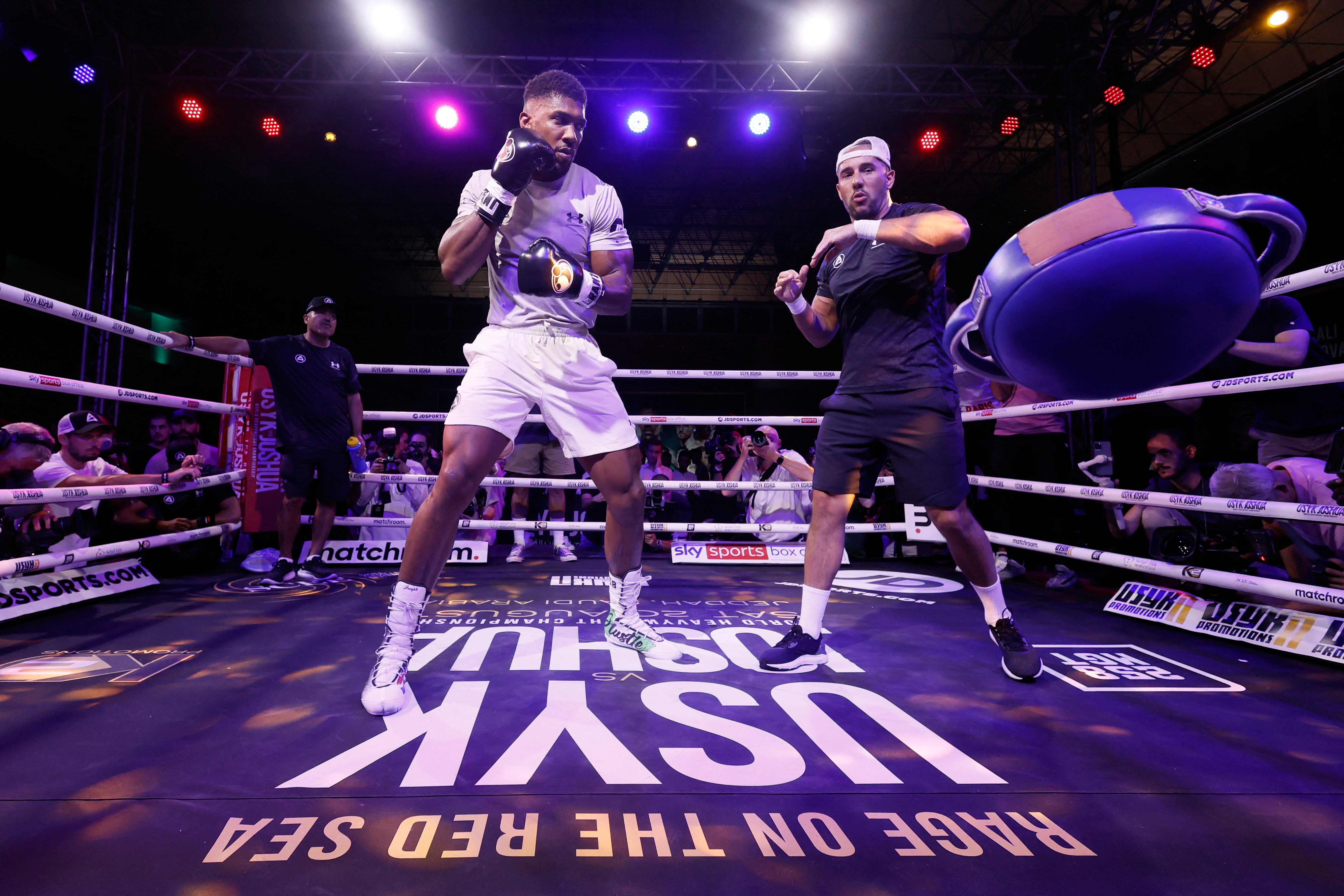 Anthony Joshua smashes a punching bag out of Angel Fernandez’s hands