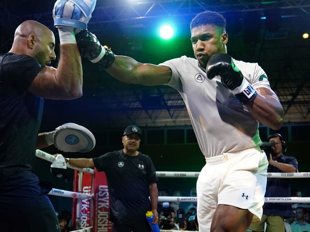 <p>Anthony Joshua (right) with coaches Robert Garcia (centre) and Angel Fernandez</p>