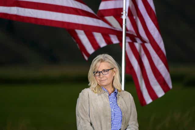 <p>Rep. Liz Cheney, R-Wyo., waits by flags before speaking, Tuesday, Aug. 16, 2022, at an Election Day gathering in Jackson, Wyoming</p>