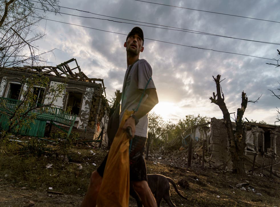 <p>A man walks past homes damaged by a rocket attack in Kramatorsk, Ukraine, in August 2022 </p>