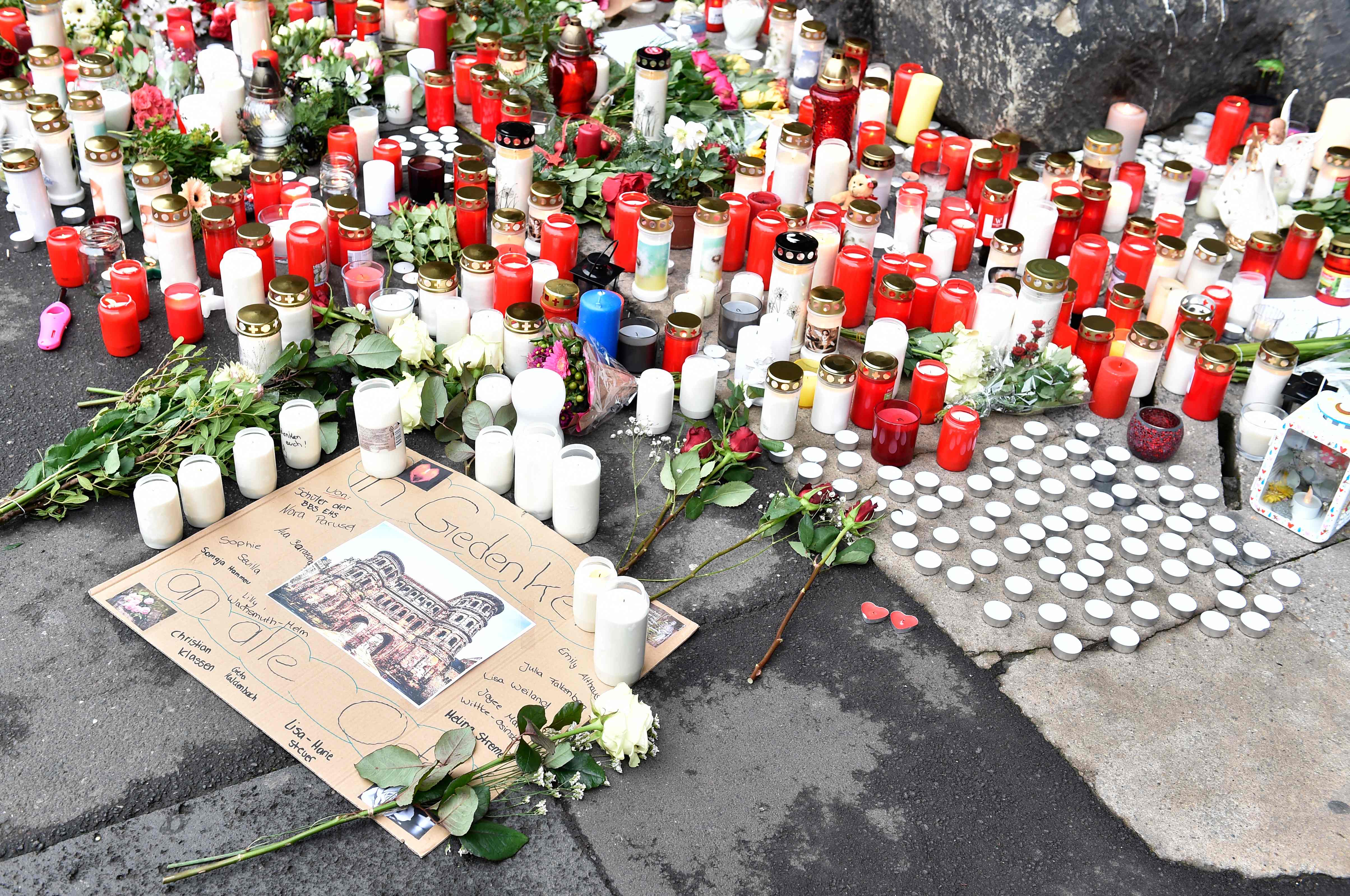 Candles and flowers are laid out to remember the victims of the attack on 1 December, 2020.