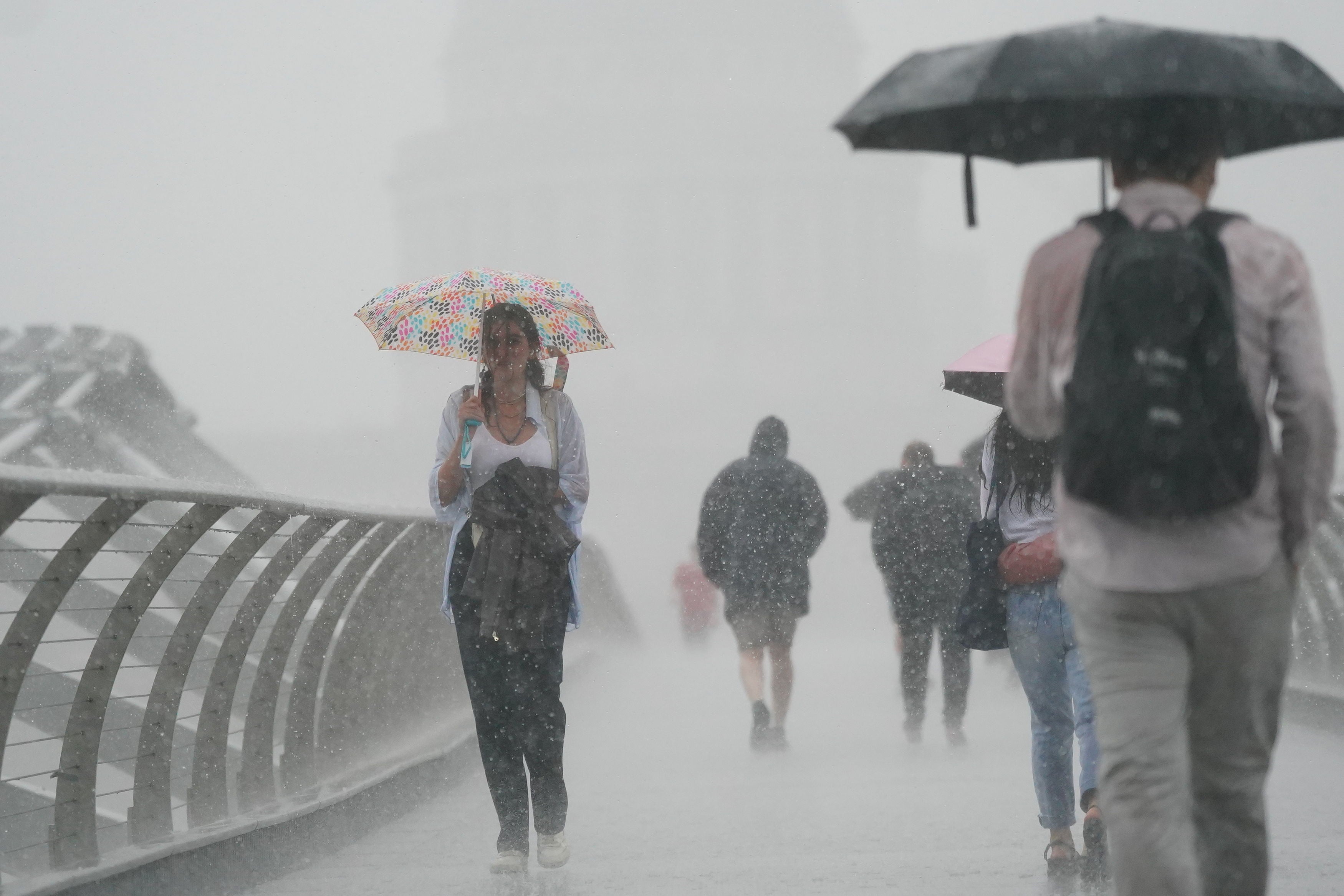 London’s Millennium Bridge as rain fell heavily for the first time after the heatwave