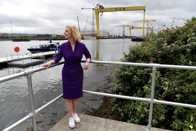 Liz Truss standing next to the Pioneer foil boat that is used to transport crew in offshore wind farms during a campaign visit to the maritime engineering company in Belfast Harbour, as part of her campaign to be leader of the Conservative Party and the next prime minister (Clodagh Kilcoyne/PA)