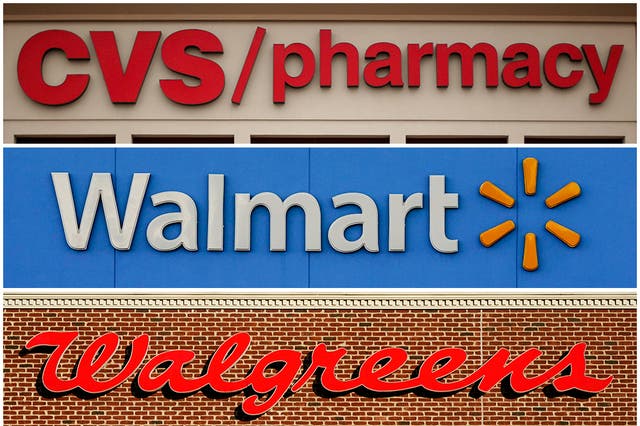 <p>This undated combination of file photos show the signs of CVS, Walmart and Walgreens </p>