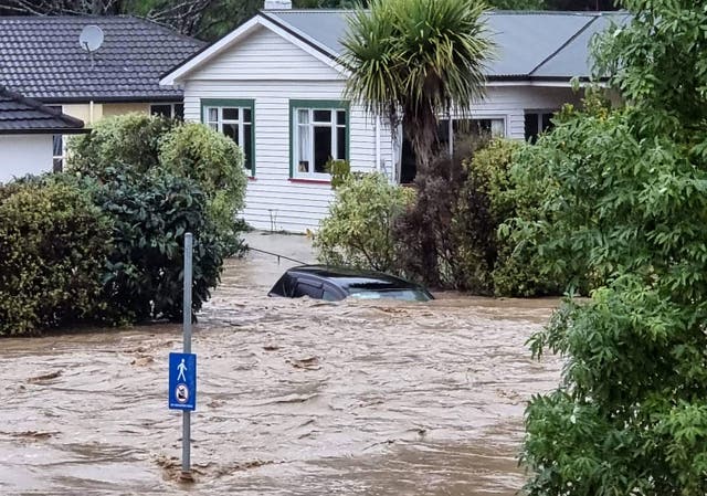 <p>A flood-inundated car and homes from the overflowing Maitai River in central Nelson</p>